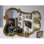 A gilt ornate overmantel mirror,