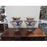 A pair of 19th Century Coalport style lidded urns with handpainted floral cartouches,
