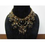 A vintage Christian Dior festoon necklace in varying shades of amber coloured crystal,