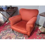 An Edwardian red velour armchair with square tapering legs to castors