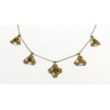A gold necklace hung with five citrine pendants,