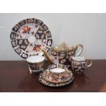 A Royal Crown Derby teaset comprising of teapot, cups and saucers, dishes etc,