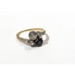 A sapphire and diamond crossover ring .50ct diamond and sapphire flanked by two .