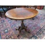 A Victorian figured walnut oval occasional table with carved pedestal base,