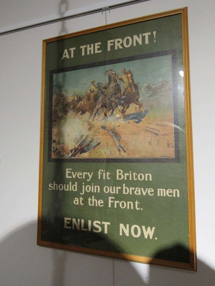 AT THE FRONT! EVERY FIT BRITON SHOULD JOIN OUR BRAVE MEN AT THE FRONT. ENLIST NOW.