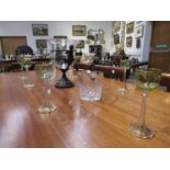 Seven Continental wine glasses with green tinted bowls, shaped wavy bases and hand gilding,