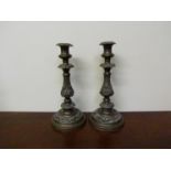 A pair of 19th Century embossed copper candlesticks,