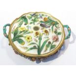 A late 19th Century Mintons floral encrusted pot pourri bowl with twin handles some petals and