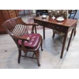 A 20th Century mahogany desk chair with red leather seat