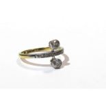 An 18ct gold diamond ring the centre band set with six diamond chips flanked by two collet diamonds,