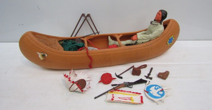 A Marx Toys Indian with accessories in plastic canoe