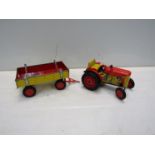 A clockwork tinplate tractor and trailer with key