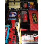 A box of boxed diecast vehicles including fire engines