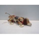 A Fisher Price Snoopy pull a long dog with waggy tail