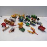 A box of Britains farm vehicles and accessories