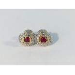 A pair of heart shaped ruby and diamond earrings