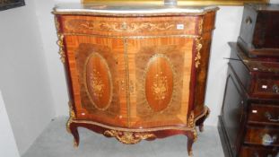 An inlaid serpentine marble top sideboard with ormolu mounts