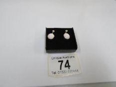 A pair of gold and opal earrings