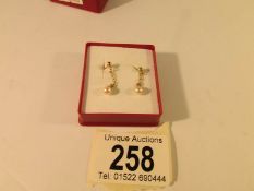 A pair of pendant earrings set with cultured pearls and with 9ct gold stud backs