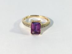 An amethyst ring with diamond shoulders in gold