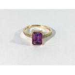 An amethyst ring with diamond shoulders in gold