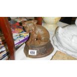 A cast iron pig door stop with crest