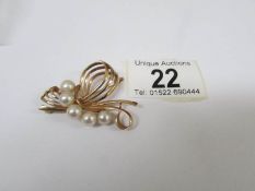 A 1970's 14ct gold brooch set with 5 cultured pearls