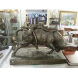 A large 20th century bronze bull with semi nude female reclining across the top,