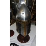 A replica medieval sugar loaf helmet