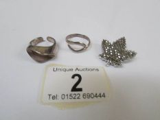 2 silver abstract rings and a marcasite maple leaf brooch