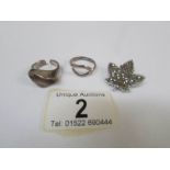 2 silver abstract rings and a marcasite maple leaf brooch