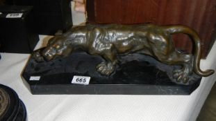 A French bronze female lion on marble stand medallion on back