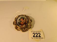 A 19th century yellow metal swivel brooch/pendant with painted portrait to front and photo to back