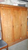 A triple door light oak wardrobe