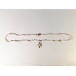 A pearl necklace with diamond set gold clasp and gold mounted drop pendant