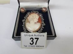 A vintage cameo brooch set with marcasite and surmounted with a ribbon in silver together with a