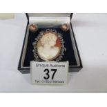 A vintage cameo brooch set with marcasite and surmounted with a ribbon in silver together with a