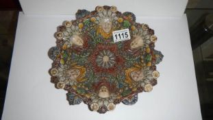An early possibly 16th century majolica palissy dish decorated with central flower,