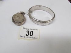 A vintage silver bangle and a Victorian locket