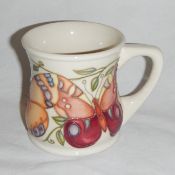 A Moorcroft 'Butterfly' mug designed by Rachel Bishop