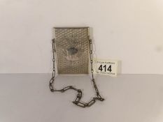 An unmarked white metal card case on chain,
