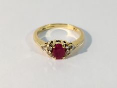 An 18ct gold claw set ring with oval ruby and diamond set shoulders,