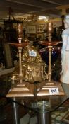 A pair of arts and crafts brass and copper candlesticks by W.A.S.