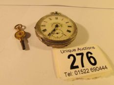 A Victorian ladies silver fob watch with key
