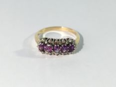 A yellow gold ring set 5 amethysts surrounded by diamonds,