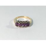 A yellow gold ring set 5 amethysts surrounded by diamonds,