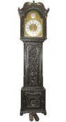 A carved oak brass faced Grandfather clock in working order