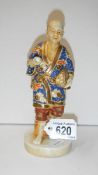 A Japanese figure of a man carrying eggs with a cloissonne' effect