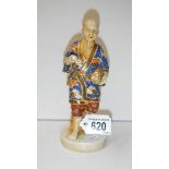 A Japanese figure of a man carrying eggs with a cloissonne' effect