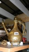 A 19th century middle eastern brass coffee pot